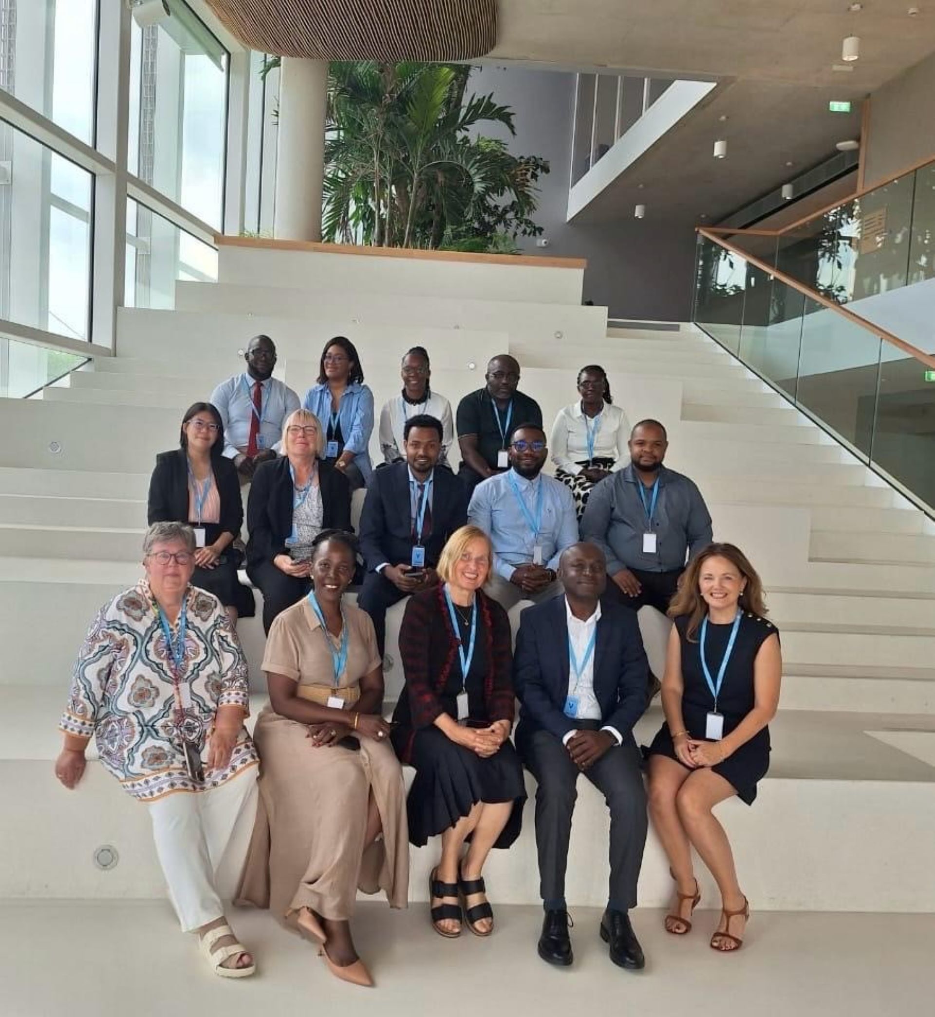 Group of experts sitting on stairs and smiling